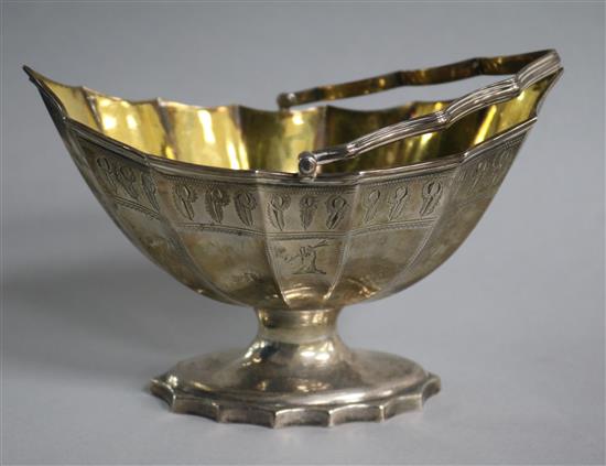 A George III silver bats wing boat shaped sugar basket, with gilt interior, by Robert Hennell, London, 1789, 6.5 oz.